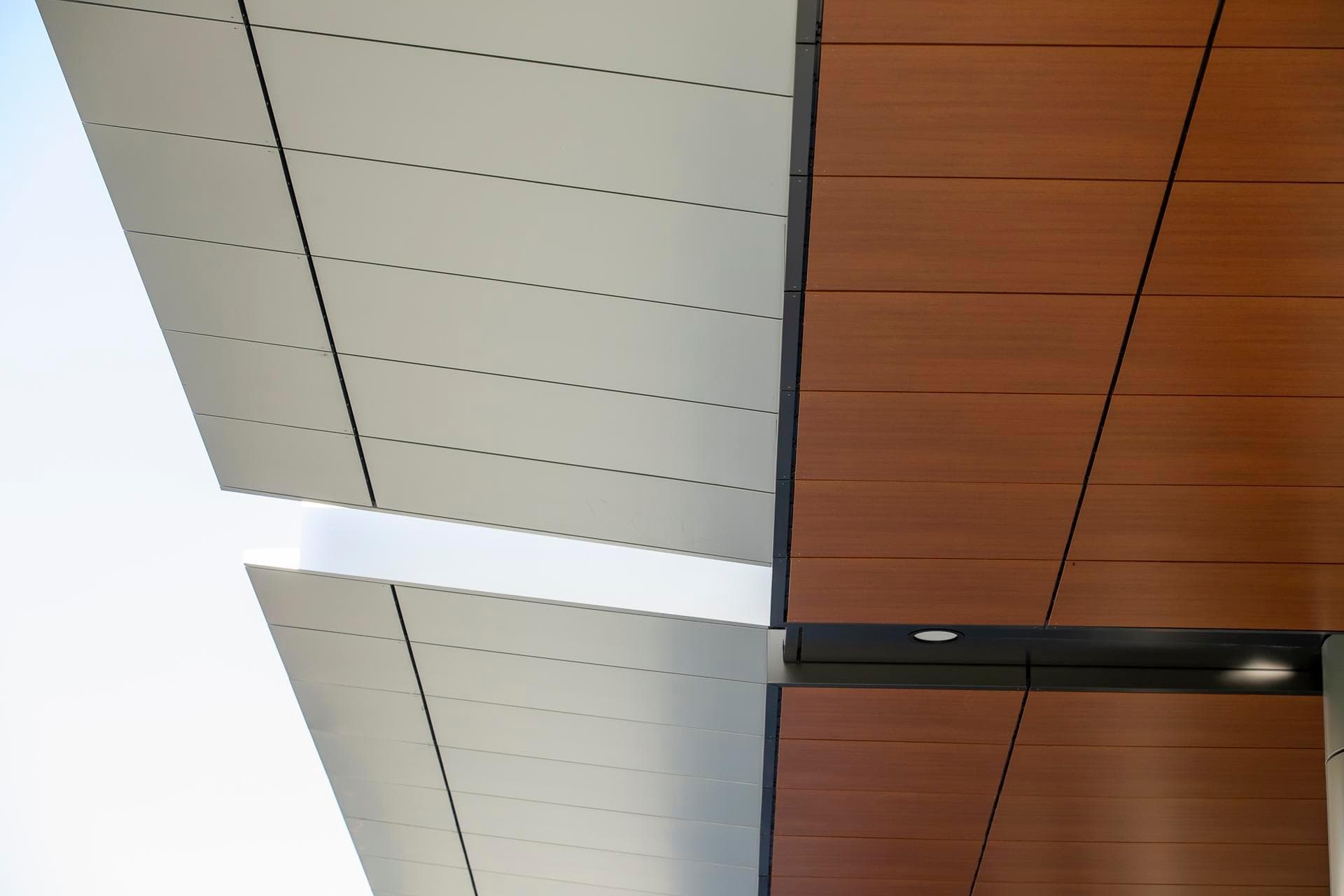 Close-up view of Alpolic NC aluminium composite panels in silver and woodgrain finish on the soffit of the Charles Perkins Centre.