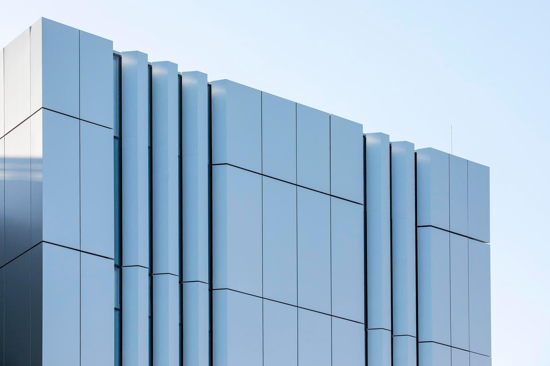 Detailed shot of Alpolic NC vertical façade panels on the Charles Perkins Centre, highlighting geometric lines and textures.